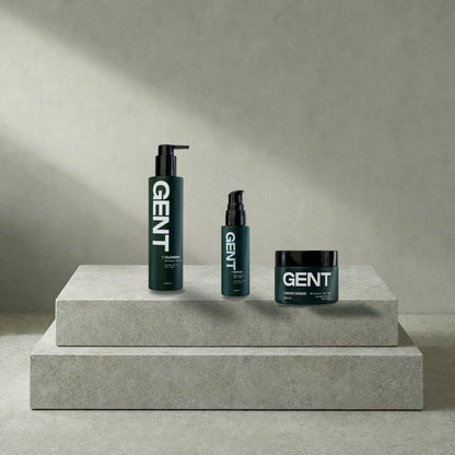 The GENT cleanser, serum and moisturiser together on a stone plinth